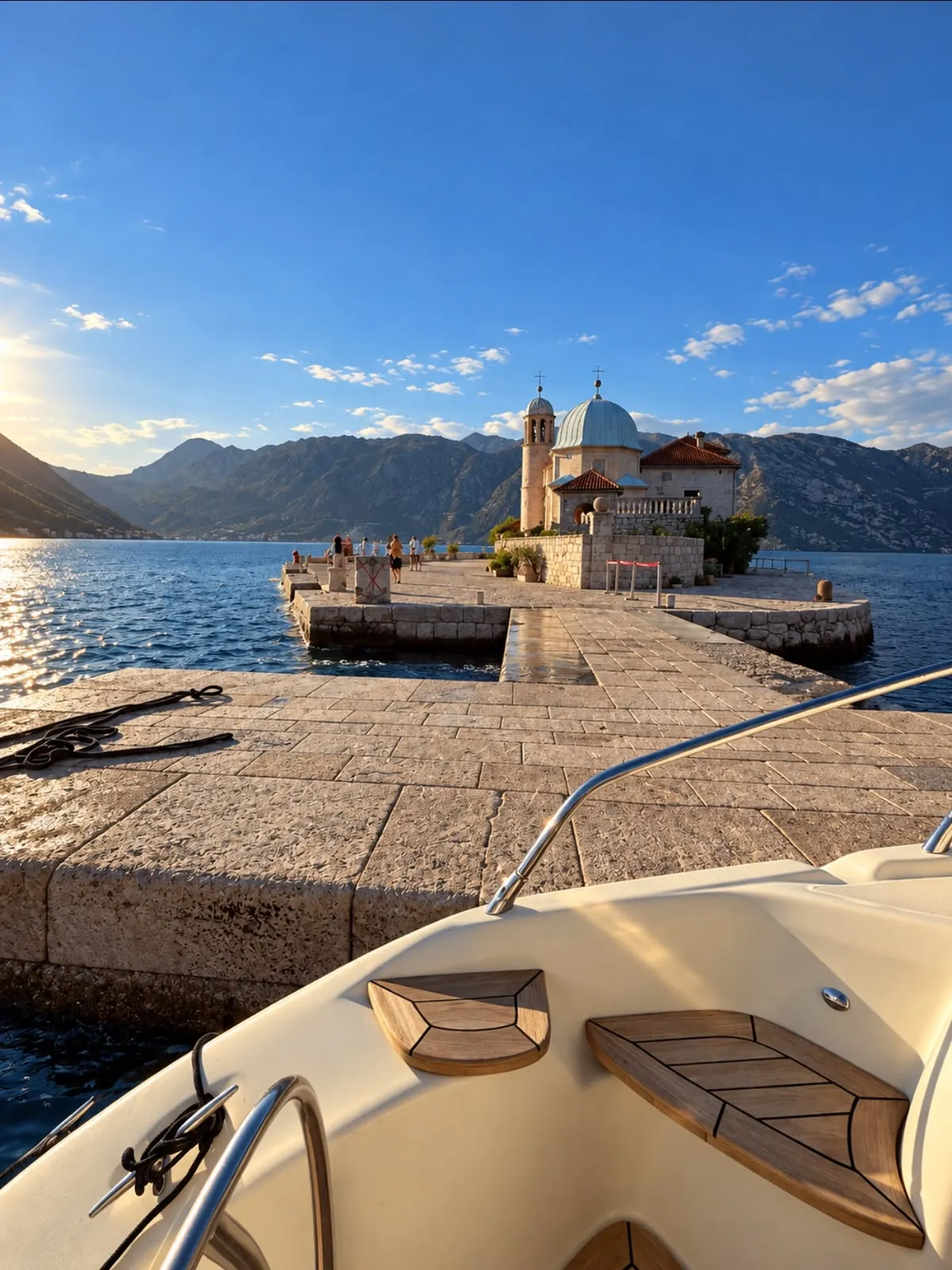 Our Lady of the Rocks seen from the bow of a yacht moored at the island
